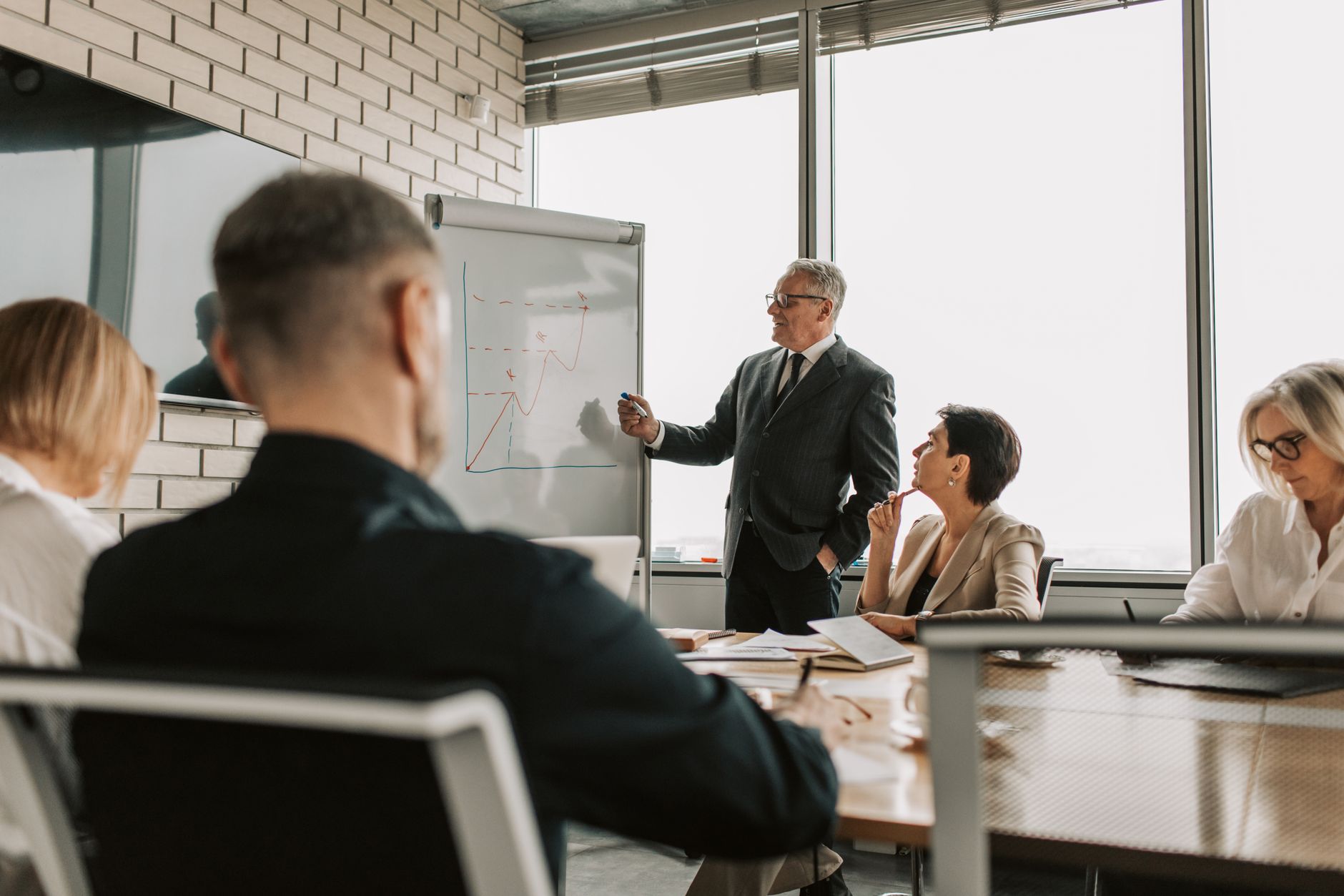 Corporate financial advisors discussing structural operational cash flow cycles